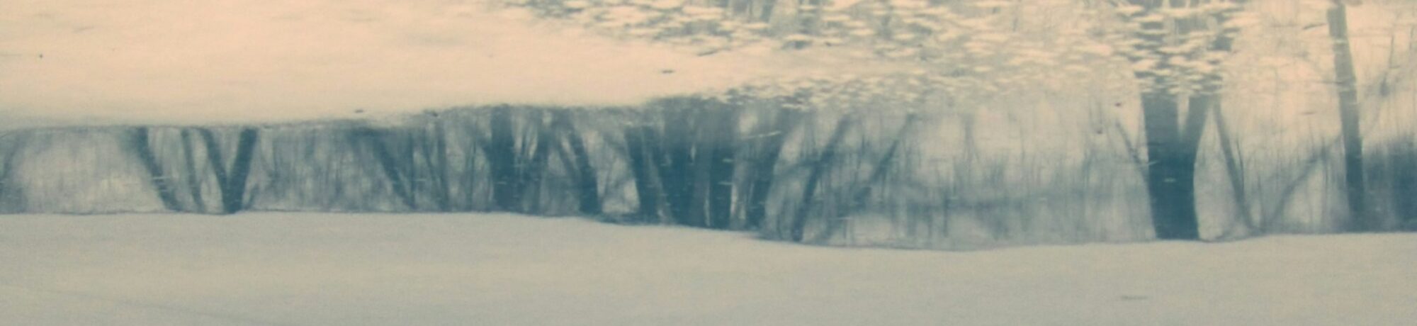 a man riding a snowboard down a snow covered slope